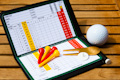 Golf scorecard with golfing accessories